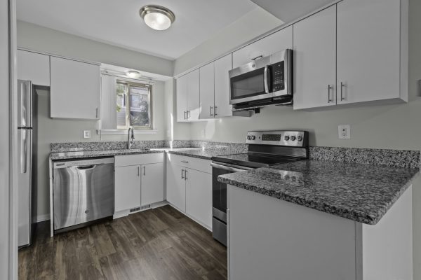Modern kitchen with granite countertops, stainless steel appliances, and white cabinets for a sleek design.
