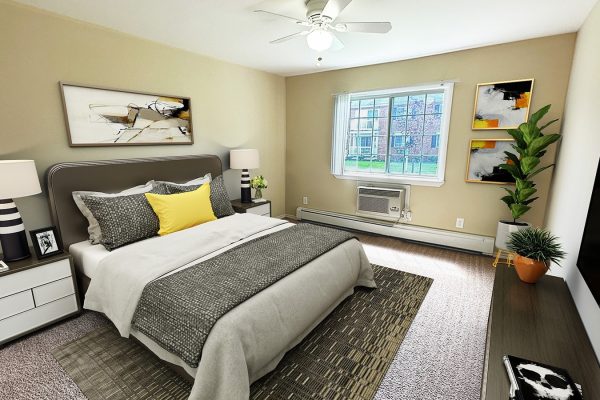 Modern bedroom with stylish decor, abstract art, large window, and cozy bed with gray and yellow accents.