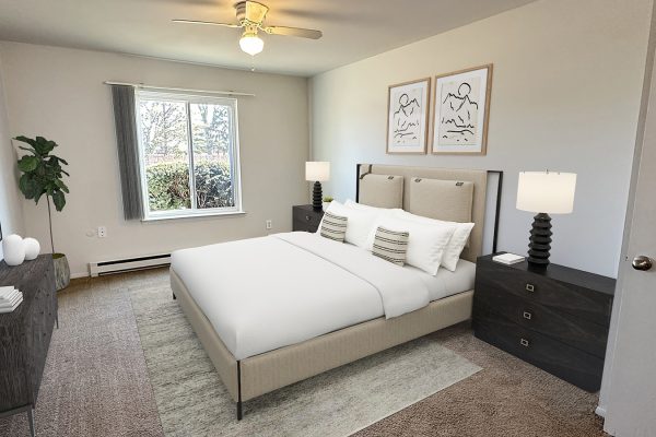Modern bedroom with a plush bed, stylish decor, and large window for natural light, creating a cozy and inviting space.