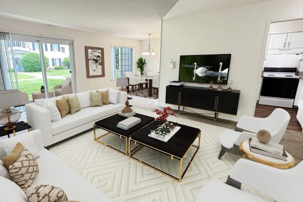 Modern living room design with white sofas, glass table, art, and large windows opening to a green backyard.