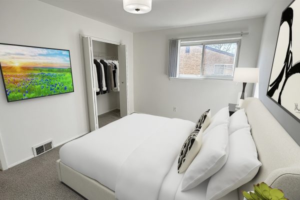 Modern bedroom with white bedding, abstract black and white art, and a scenic landscape TV on the wall.