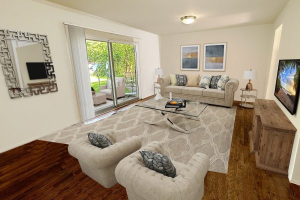 Cozy living room with beige sofas, glass coffee table, large mirror, and sliding door to patio view.