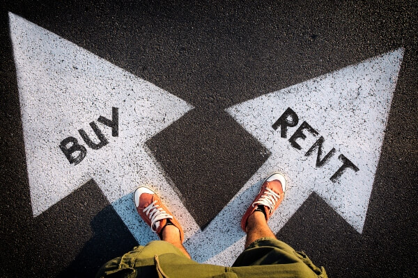 Person standing on a road with arrows labeled Buy and Rent, representing a decision-making concept.