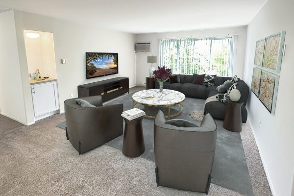 Modern living room with gray sectional sofa, marble coffee table, and wall-mounted TV, featuring elegant décor and large window.