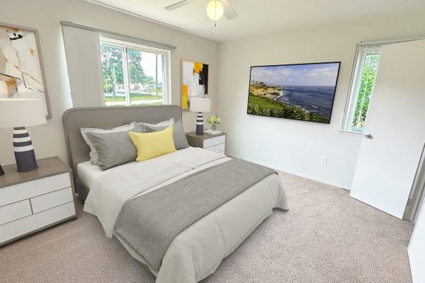 Neutral-toned bedroom with modern decor, abstract art, and a scenic landscape on the wall-mounted TV.