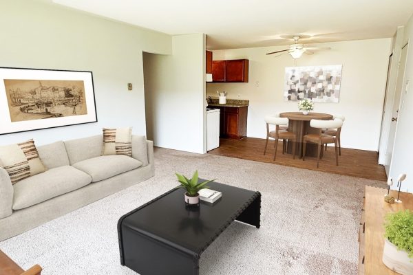 Modern apartment living room with cozy furniture, dining area, and wall art, ideal for comfortable living.