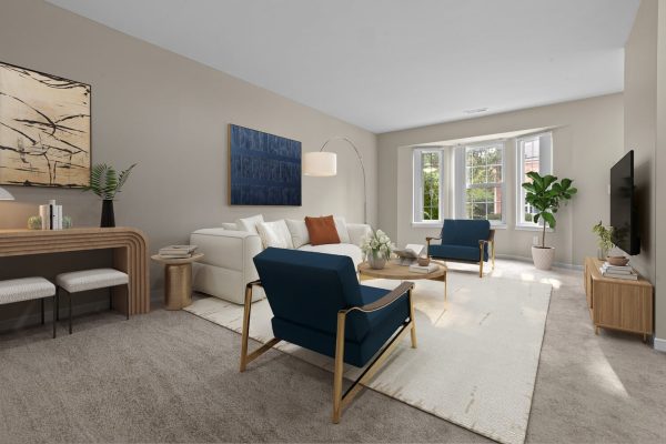 Modern living room with blue chairs, beige sofa, large windows, and stylish decor.