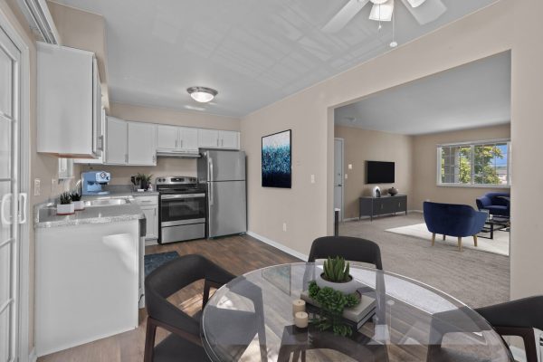 Modern open-concept kitchen and living room with sleek furniture and elegant decor.